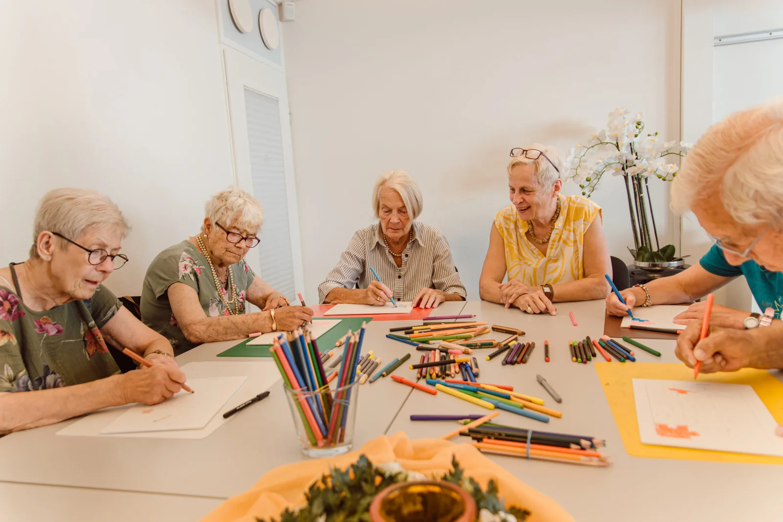 Seniorinnen malen gemeinsam am Tisch